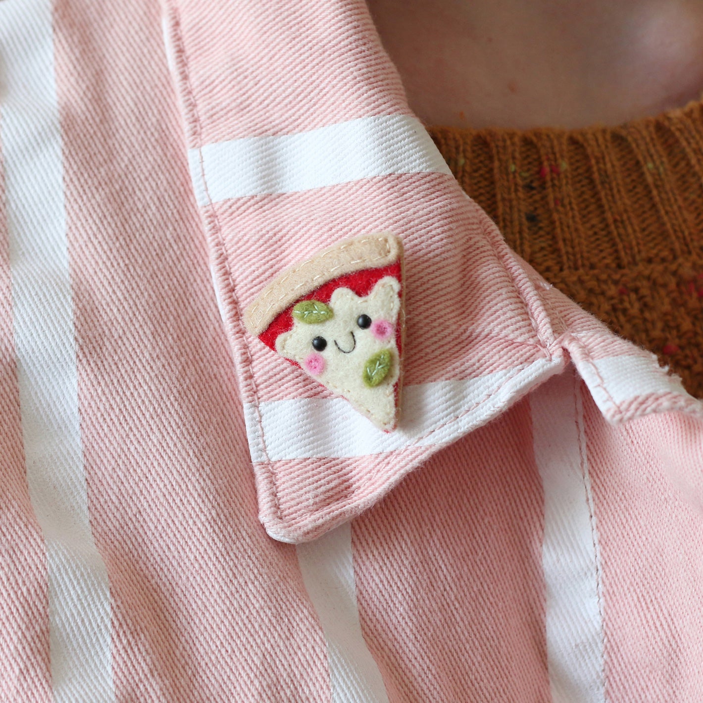 happy margherita pizza felt brooch modelled on a denim jacket
