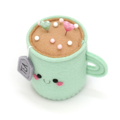 Top view of kawaii mint teacup pincushion with pins by hannahdoodle