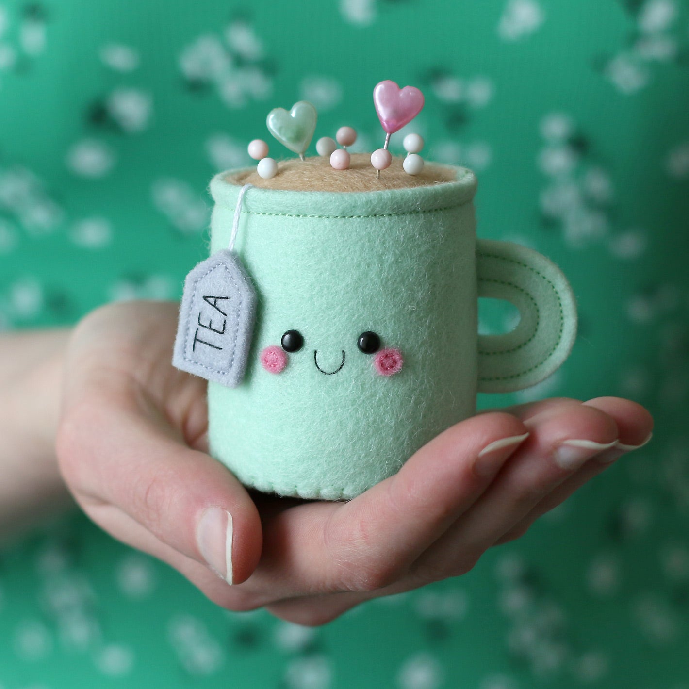 Mint tea pincushion being held