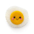 A cute, handcrafted felt egg-shaped pin with a yellow smiling face, pink cheeks, and black eyes, set against a plain white background.