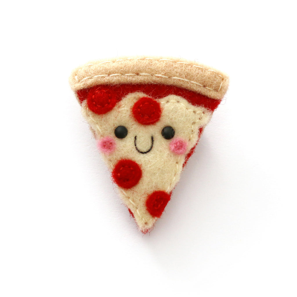 A cute, handmade felt slice of pizza pin with a smiling face, featuring red pepperoni topping, pink cheeks, and a beige crust.