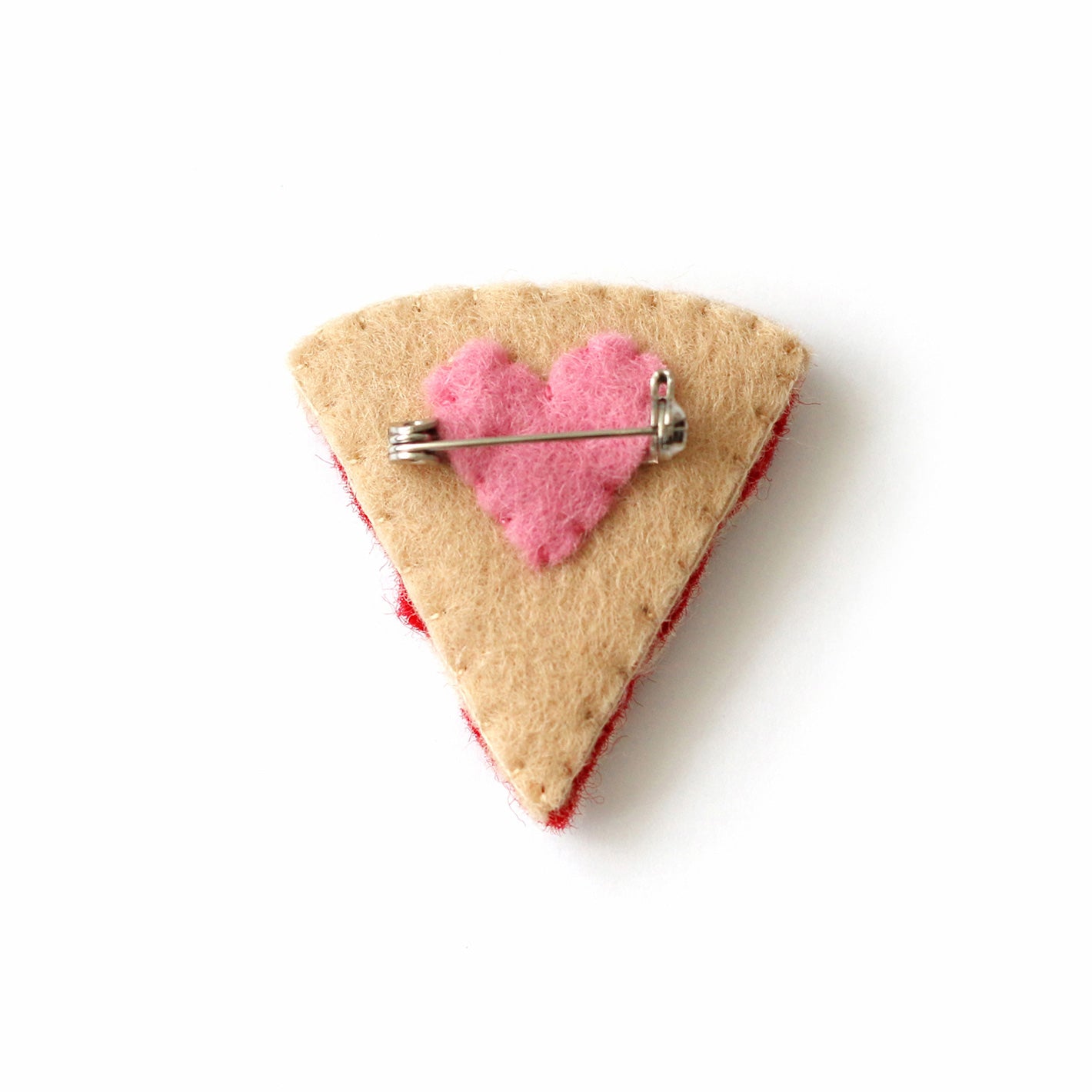 back of pepperoni pizza brooch showing brooch back and a heart shaped felt piece