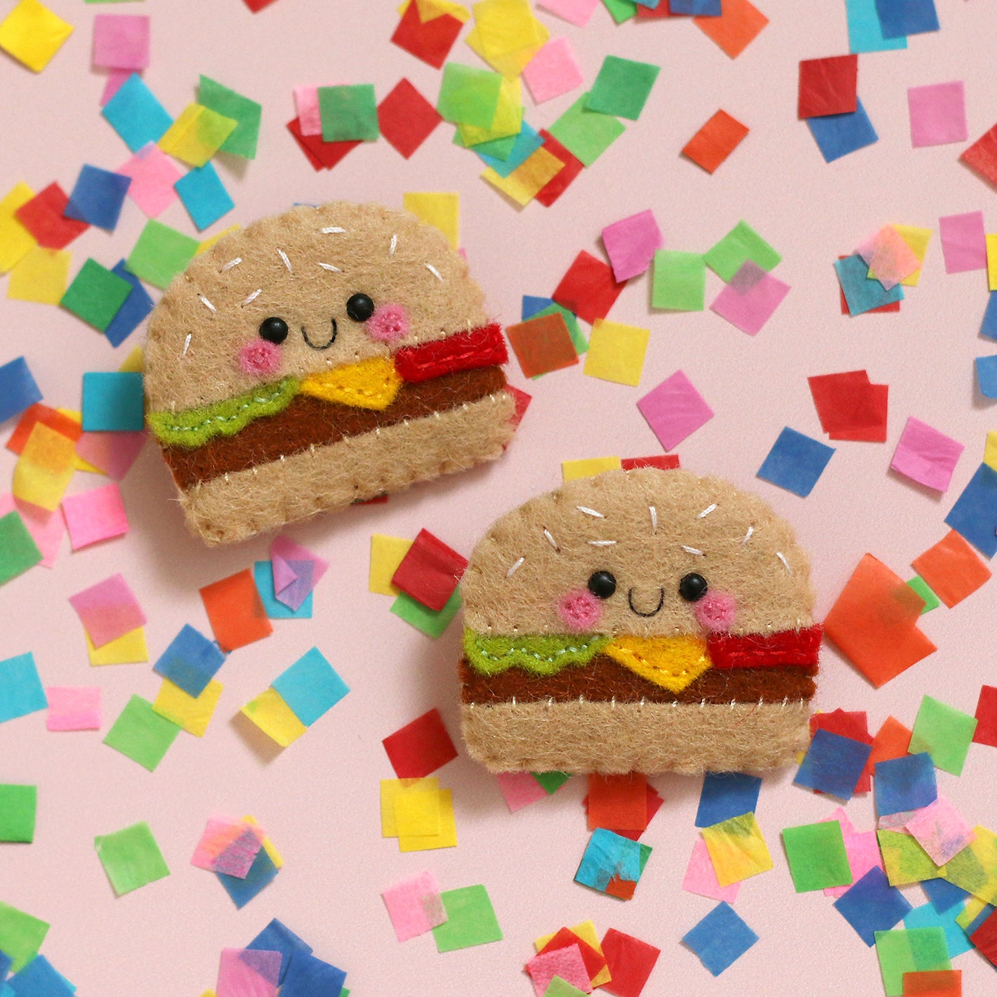Cheeseburger felt brooches on a confetti sprinkle background by hannahdoodle