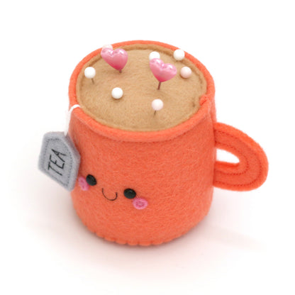Top view of cute teacup pincushion with happy face