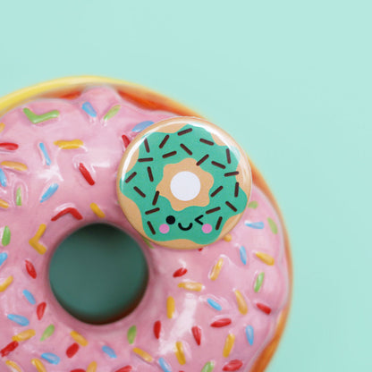 Mint donut button badge on a ceramic donut trinket box