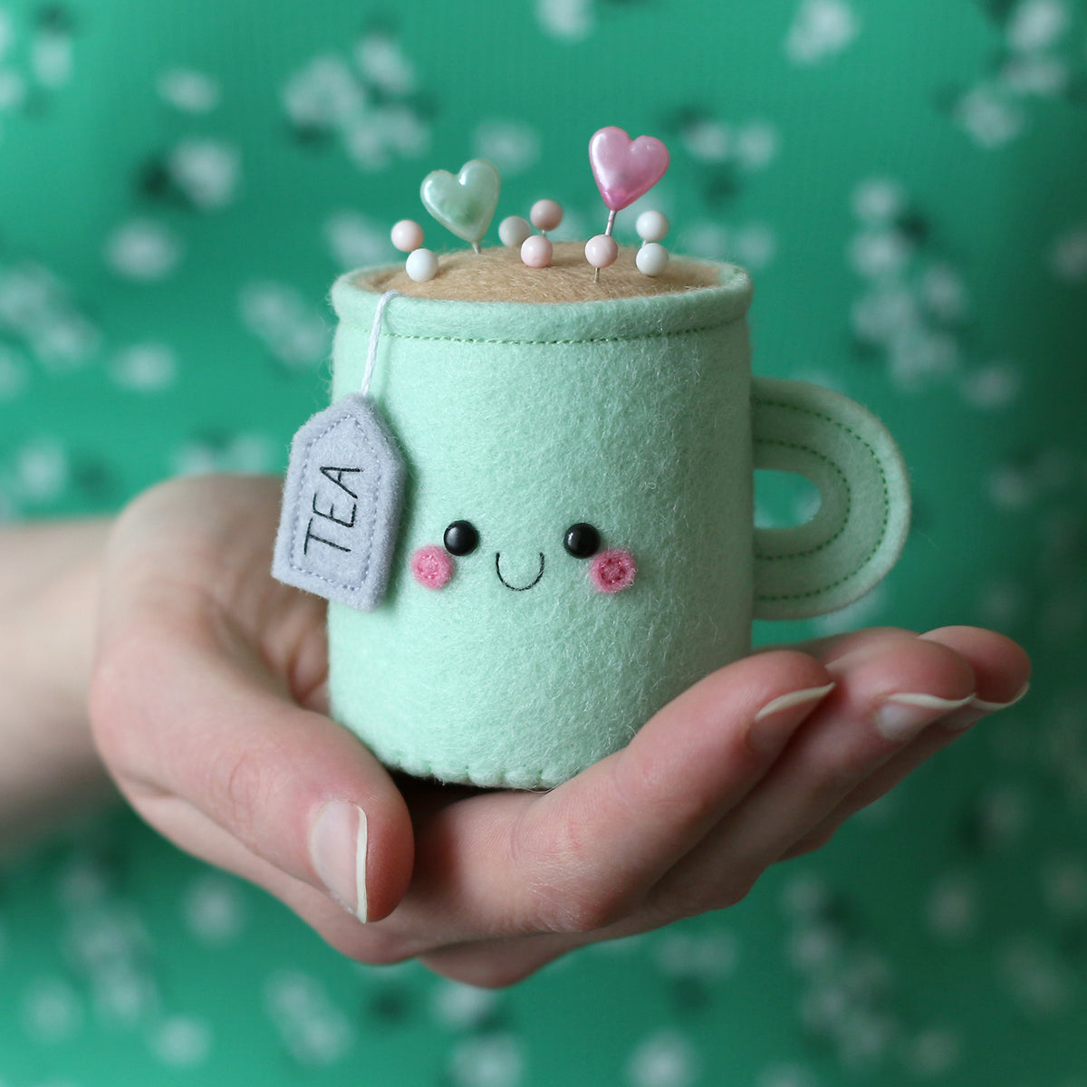 Mint tea pincushion being held