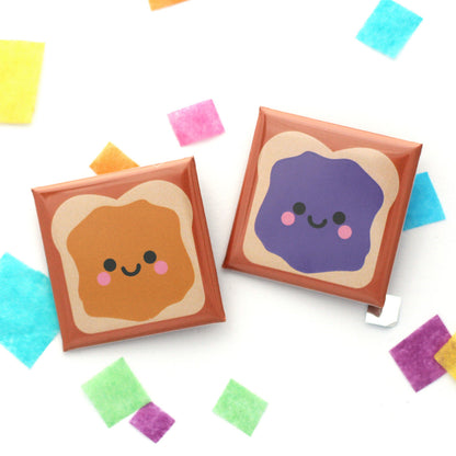 A pair of peanut butter and jelly sandwich badges